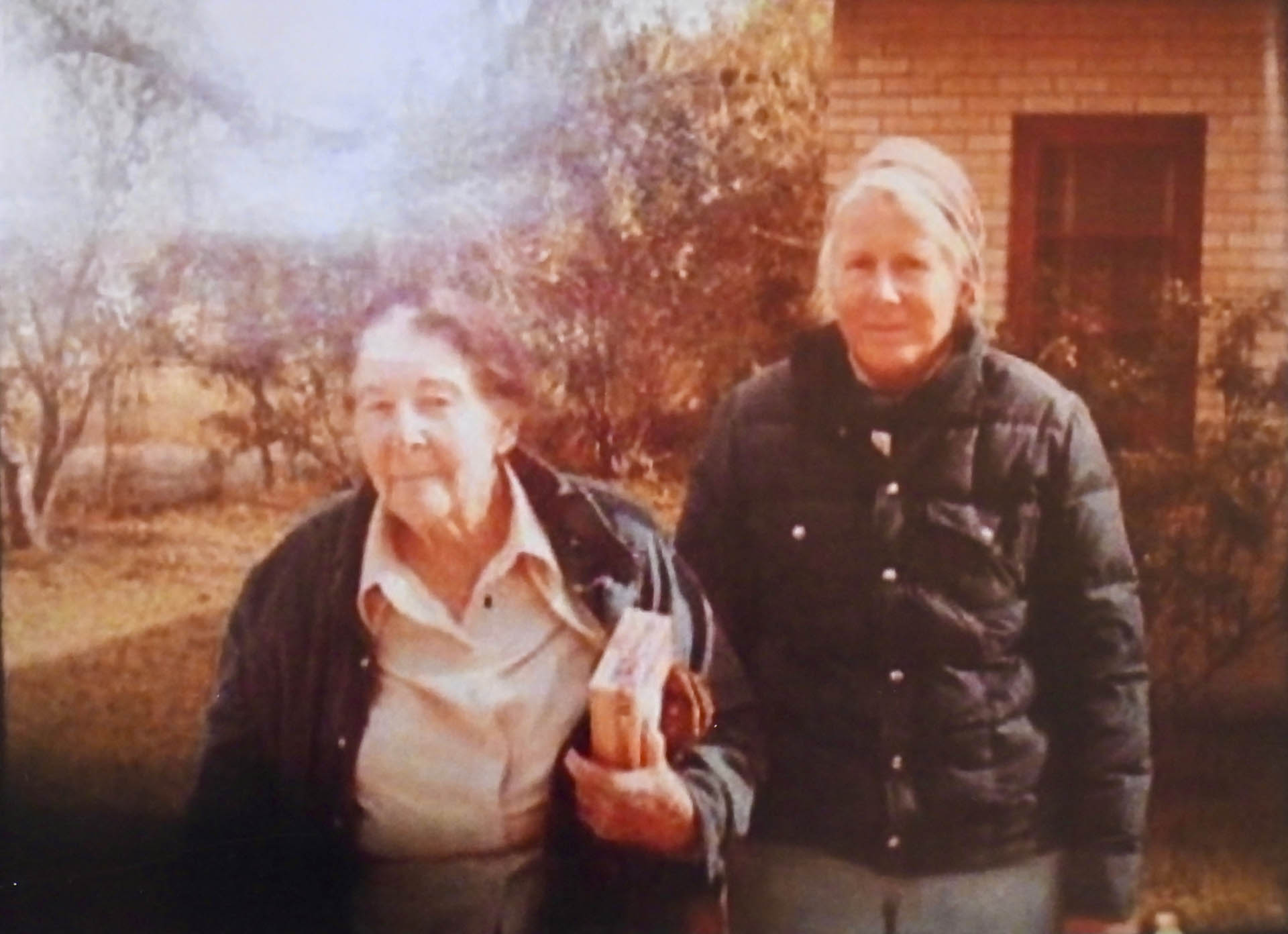 Old Mama with Lica outside the brick ranch house.